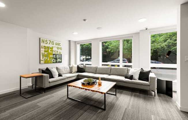 A modern living room with a grey sofa and a coffee table.