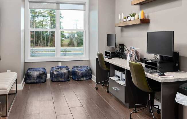 a home office with desks and chairs and a window