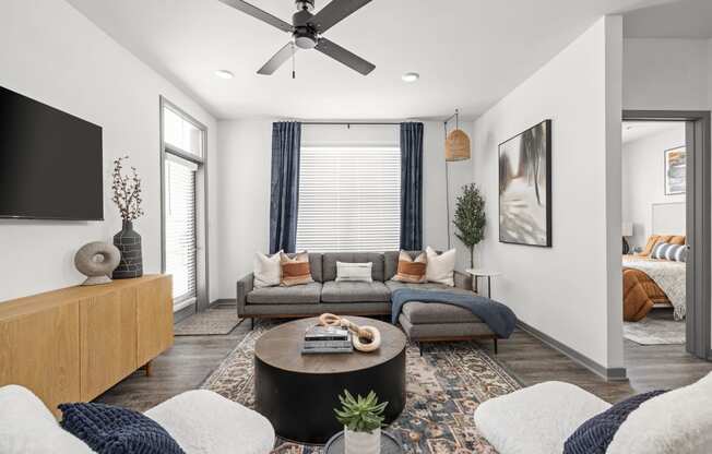 a living room with a couch and a ceiling fan