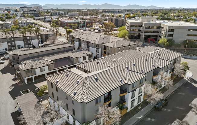 an aerial view of a group of apartment buildings in a city