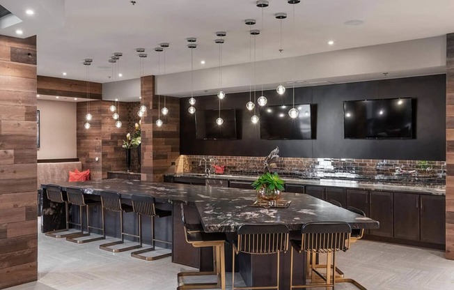 a large kitchen with a large island and chairs