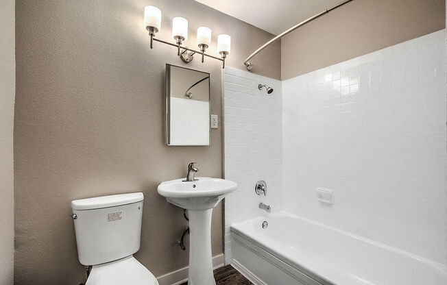 The Island Apartments bathroom vanity, toilet, and shower