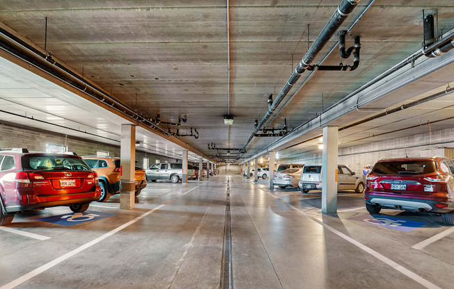 an empty parking garage with cars parked in it