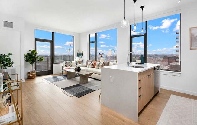 A modern kitchen with a large island and a view of the city.
