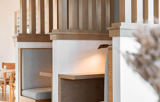 A wooden chair is placed in front of a fireplace.