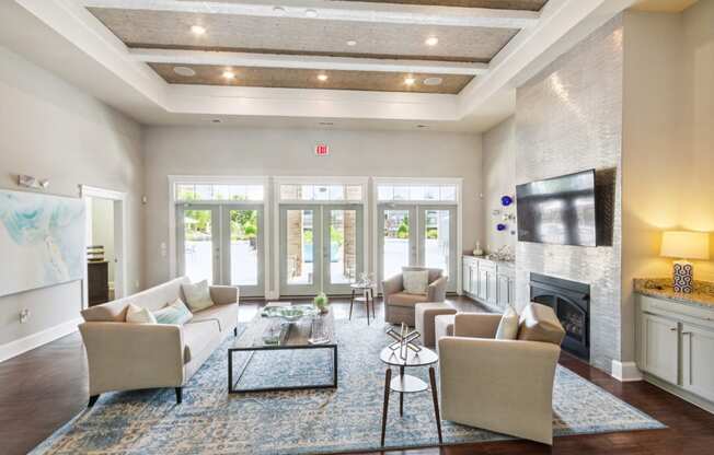 a living room with couches a coffee table and a fireplace