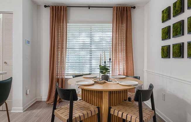 a dining area with a wooden table and four chairs