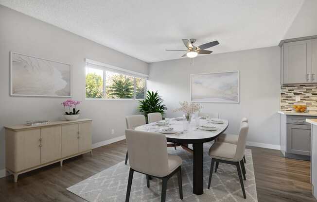 a dining room with a table and chairs and a ceiling fan at The Fulton, Los Angeles, CA