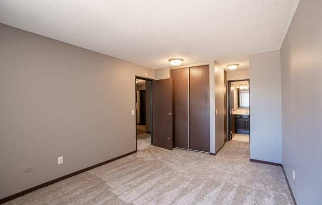 a bedroom with a closet and a bathroom