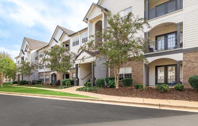 A row of townhouses with a tree in front of the first one.