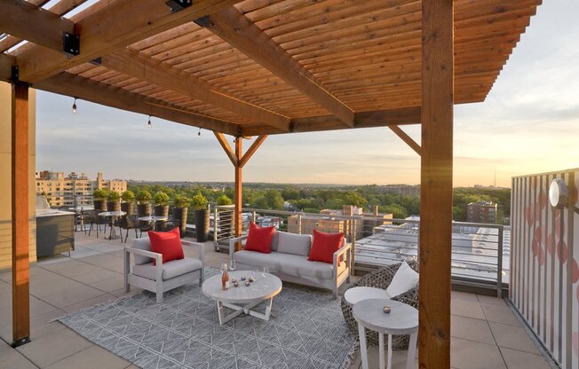 a roof deck with couches and tables