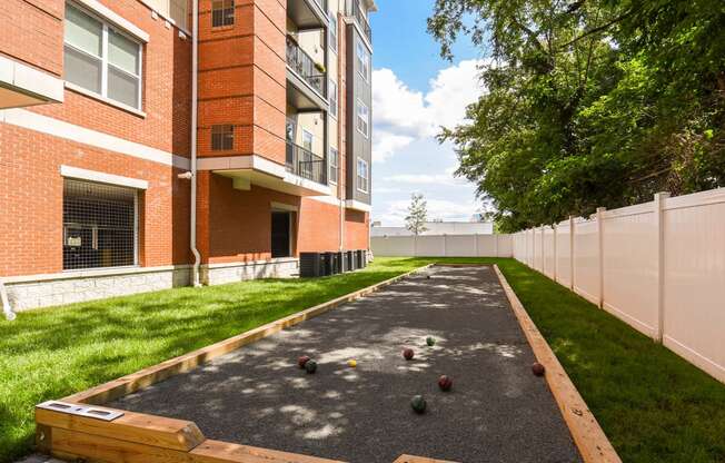 bocce ball court in front of a brick building