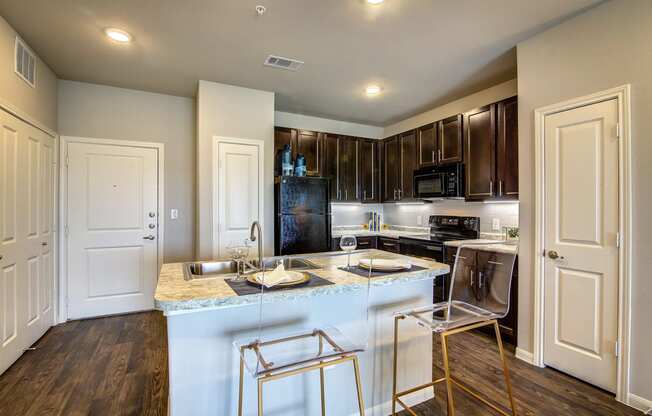 a kitchen with an island and stainless steel appliances