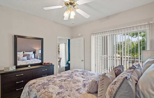 a bedroom with a bed and a ceiling fan