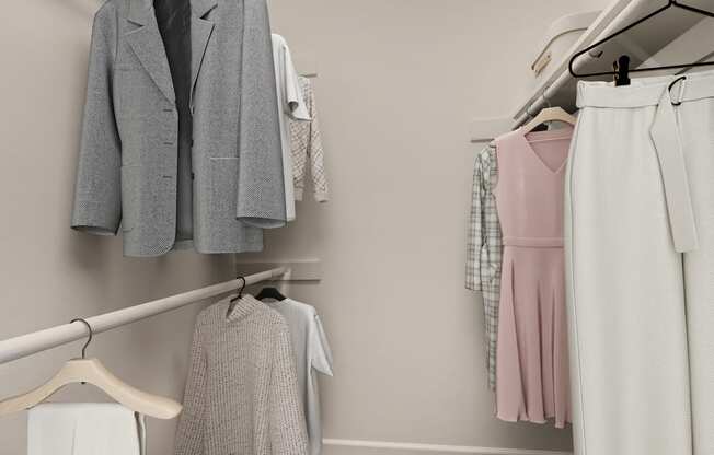 A row of clothes hangs on a clothes rack.