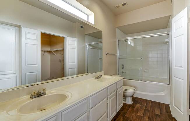 Large bathrooms with ample countertop space and double sinks at Turnberry Isle Apartments in Dallas, TX.