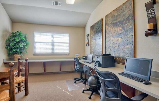 an office with two computers and two chairs