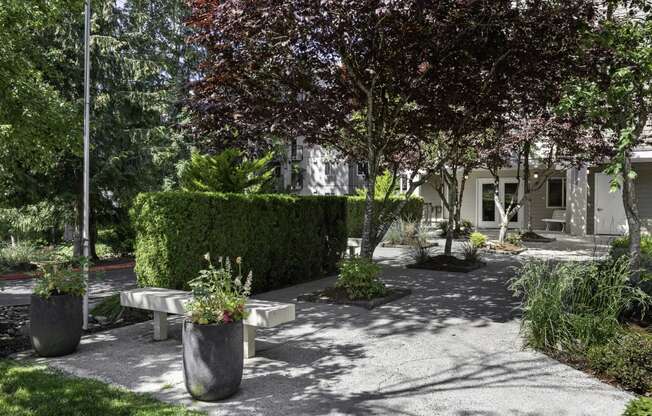 Property Courtyard with benches and planters in front for resident enjoyment at West Mall Place Apartment Homes, Everett, WA, 98208
