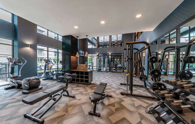 a spacious fitness center with cardio machines and weights