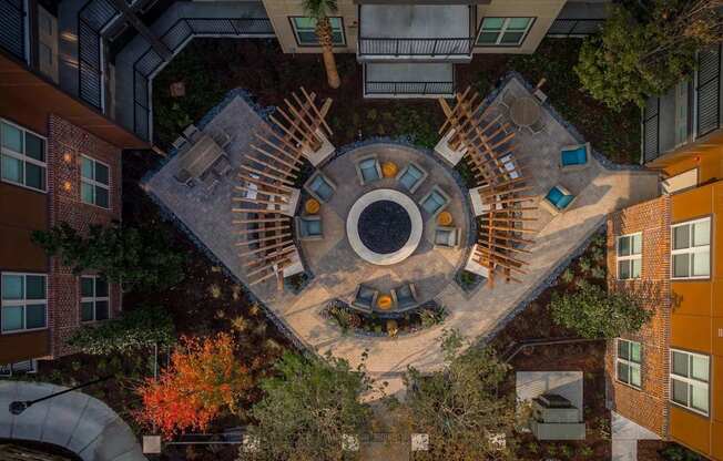 A courtyard surrounded by buildings with a circular design in the middle.
