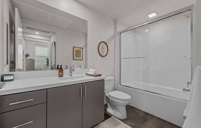 a bathroom with a shower and a sink and a toiletat Westbury Apartments, Rancho Cucamonga, California 