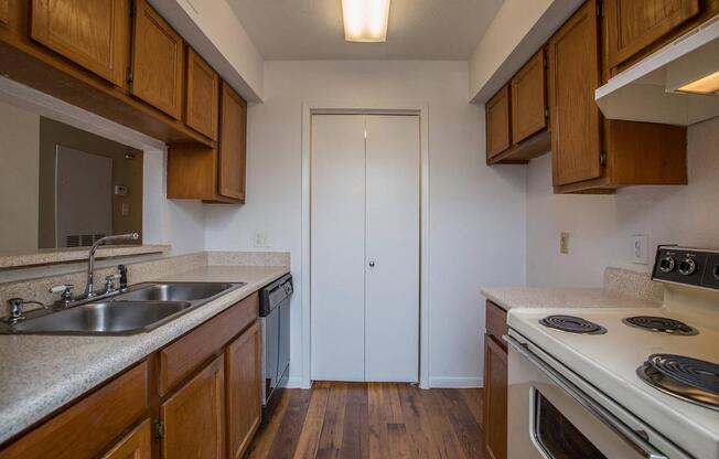 a kitchen with a stove a sink and a microwave