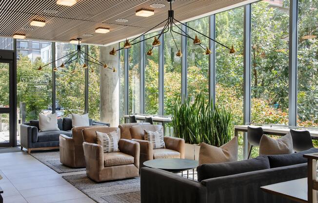 a living room filled with furniture and large windows