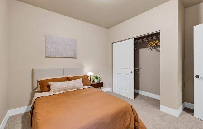 A bedroom with a bed and a painting on the wall.