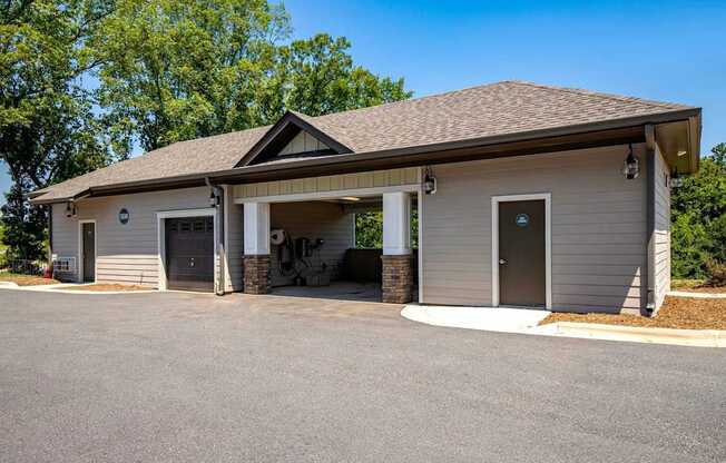 A small building with a garage door and a covered entrance.