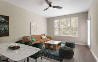 A living room with a couch, chairs, and a coffee table.