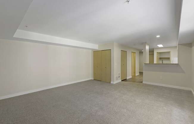 a bedroom with white walls and carpet at Excalibur Apartment Homes, Bellevue, 98004