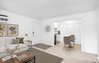 A living and dining room with plush carpeting at Granada Apartments, Jackson, 49202