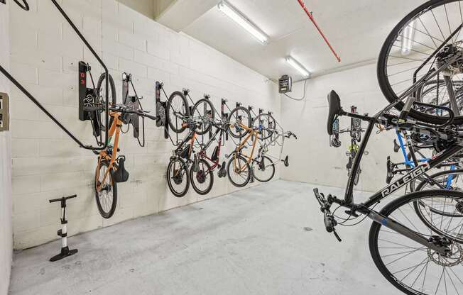 A bike shop with bikes hanging on the wall.