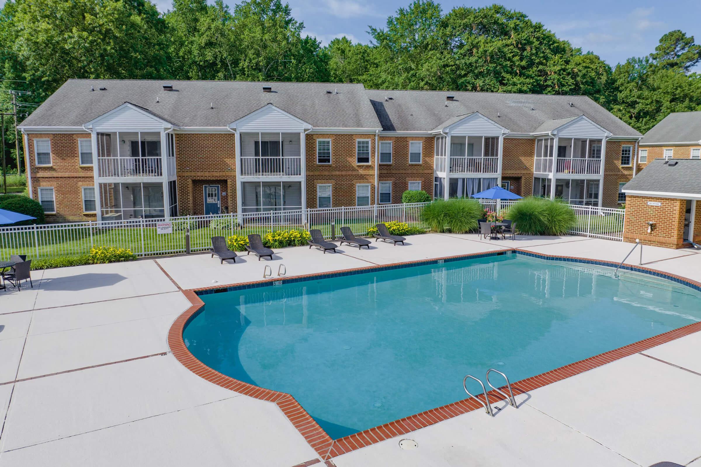 a house with a pool in front of a building