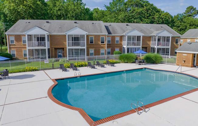 a house with a pool in front of a building