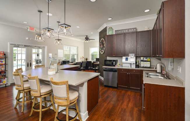 a kitchen with a center island and chairs