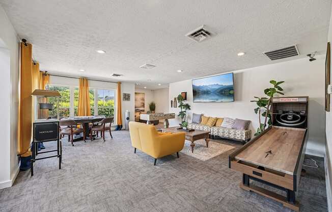 A living room with a yellow chair and a wooden table.