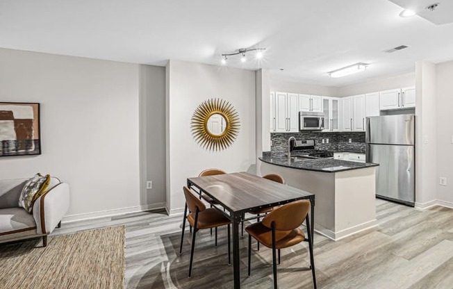 a kitchen and dining room with a table and chairs