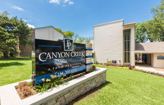 This is a photo of the entrance sign at Canyon Creek Apartments in Dallas, TX.