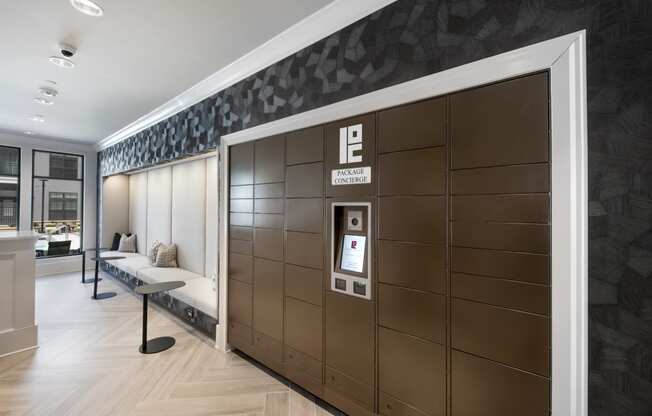 the mail center with package lockers and a bench for seating