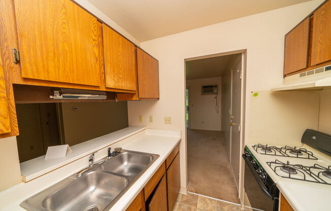 Kitchen leads to Living and Dining Areas at Trappers Cove Apartments, Lansing, MI, 48910