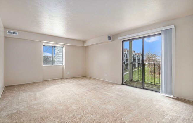 enlarged living room with an extra window and sliding glass door to a balcony