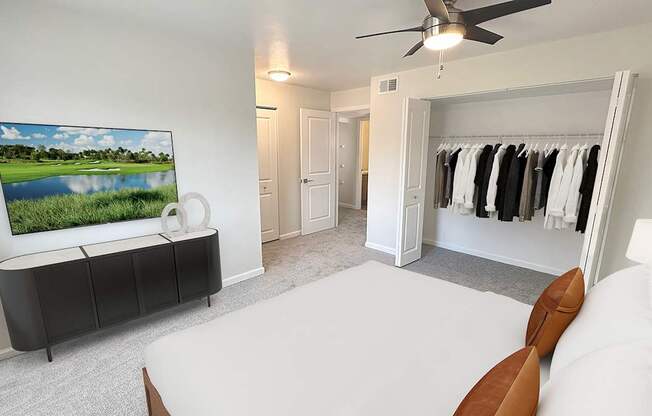 A bedroom with a large bed, a television, and a wardrobe.