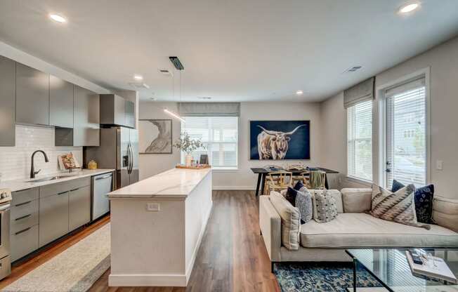 a living room with a kitchen and a couch