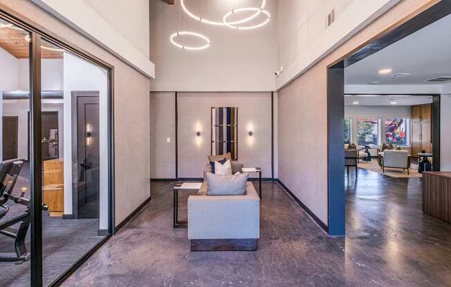 A modern living room with a marble floor and a large white sofa.