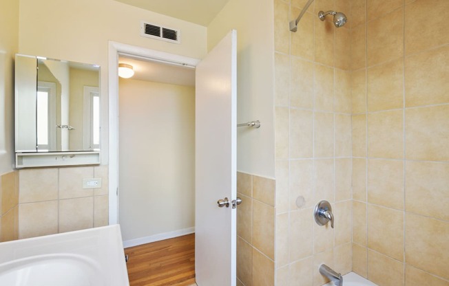 a bathroom with a shower and a toilet and a sink