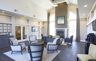 a living room with a table and chairs and a fireplace