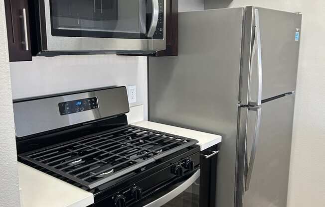 a kitchen with stainless steel appliances and a stainless steel refrigerator