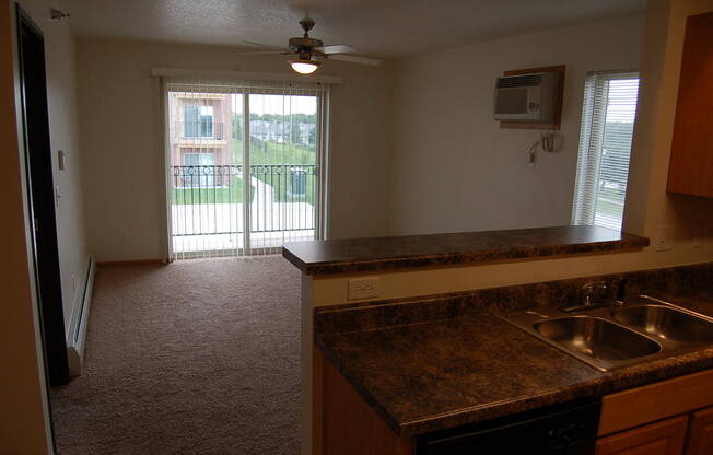 an alternate view of the kitchen and living room of a 560 square foot, 1 bedroom apartment