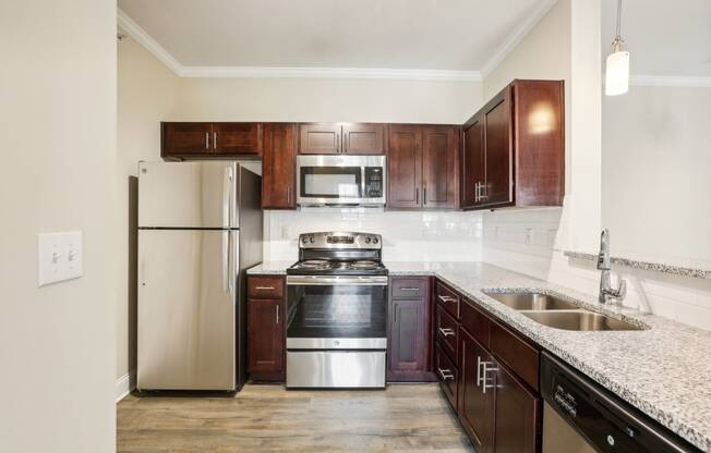 a kitchen with wooden cabinets and stainless steel appliances